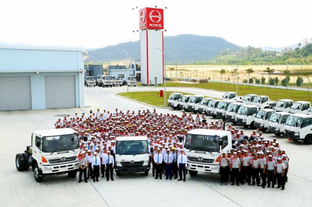 Staff and guests pose with made-in-Sendayan HINO trucks after the plant's official line-off ceremony
